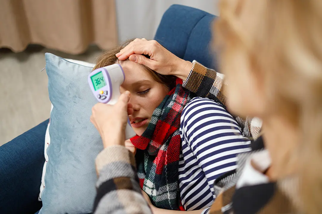 Adult experiencing sore throat and swollen glands from glandular fever