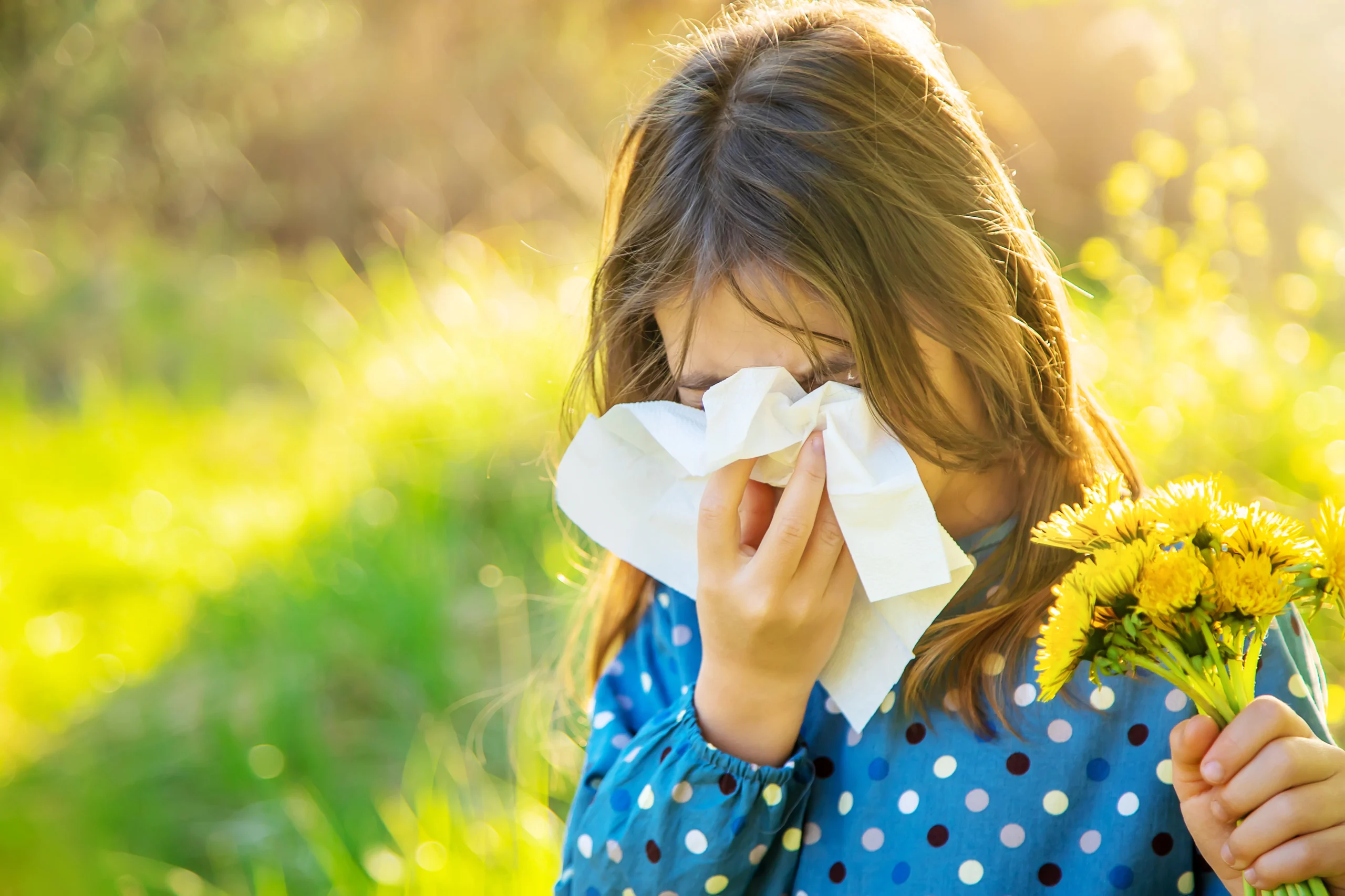 hay fever treatment London — woman outdoors in spring with itchy eyes and blocked nose